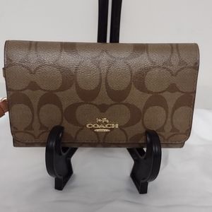 Beautiful coach signature wallet with bright pink accent color!